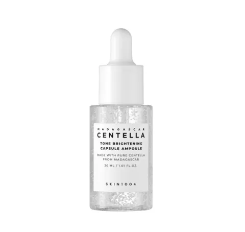 Clear dropper bottle of serum with white label and cap on a white background.
