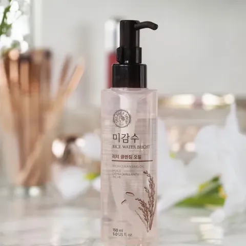 Clear plastic pump bottle with Korean text on a bathroom counter, soft background.