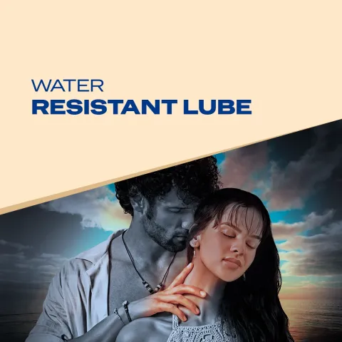 Man and woman embrace by the sea under a cloudy sky, with a beige and blue graphic overlay.