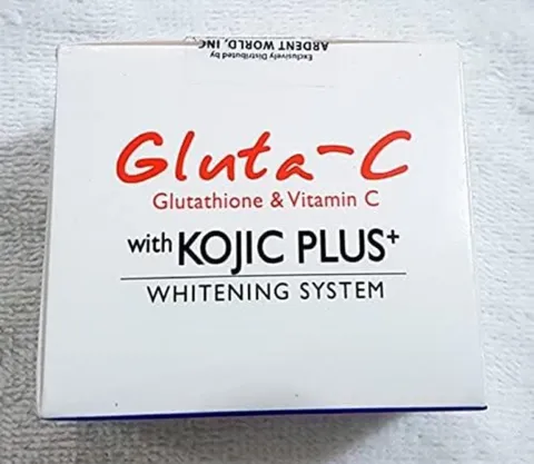 Gluta-C Kojic Plus Whitening System product packaging on a white textured surface.