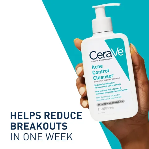 Hand holding a bottle of CeraVe Acne Control Cleanser against a blue and white background.