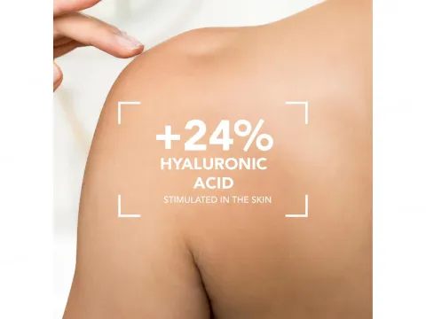 Hand touching bare shoulder with smooth, healthy skin.