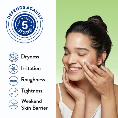 Smiling woman applies cream to her face with skincare benefit icons and text beside her.