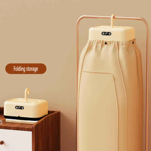 Beige folding garment steamer standing next to a compact folded version on a dresser.