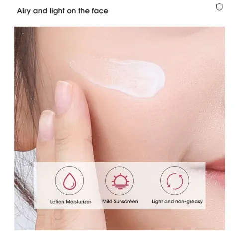 A finger applying white lotion to a person's cheek.