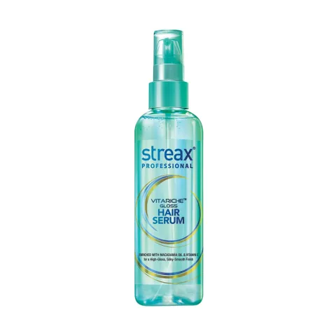Clear bottle of Streax Professional hair serum with a green pump cap.
