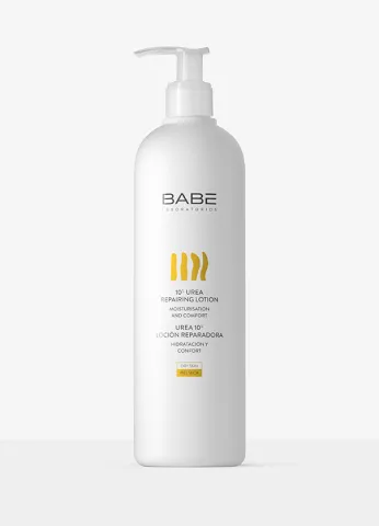 White bottle of BABÉ shampoo with yellow label and pump dispenser on a light background.