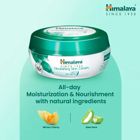 Himalaya Nourishing Skin Cream jar with green lid on a light blue background.