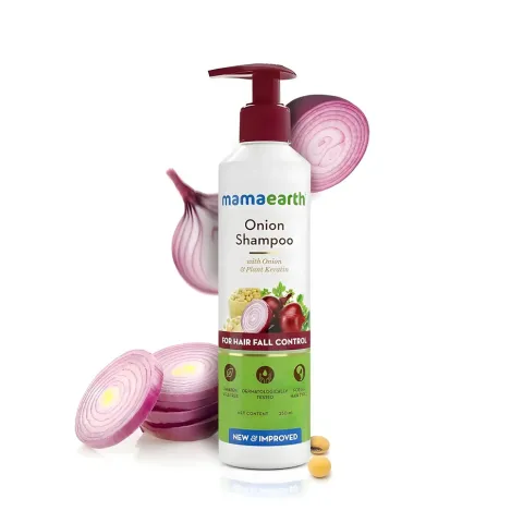Mamaearth Onion Shampoo bottle with sliced red onions and capsules in the background.