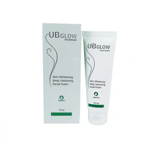 White tube and box of UB Glow skin whitening facial foam with green accents.