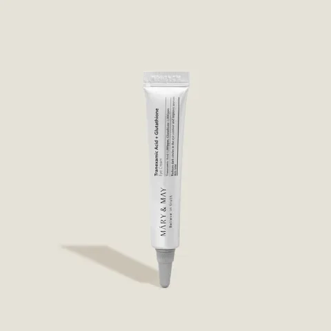 White tube of skincare product with minimal text on a plain light background.