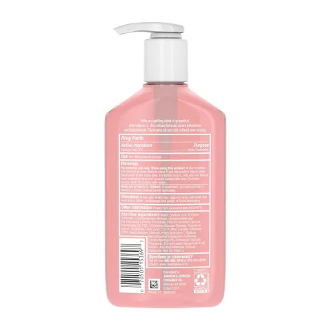 Pink pump bottle with a white label, seen from the back displaying ingredients and barcode.