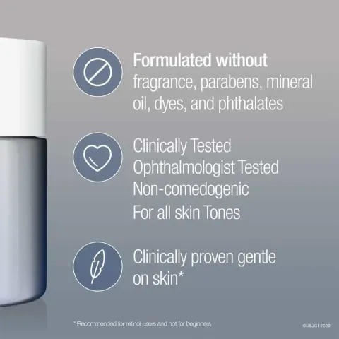 White cosmetic bottle with product claims listed beside it on a gray background.