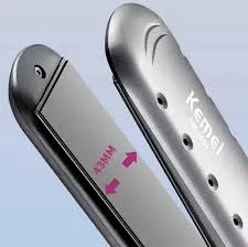 Close-up of a silver hair straightener with a reflective plate and branded surface.