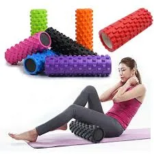 Woman using a textured foam roller on her calf, with colorful foam rollers in the background.