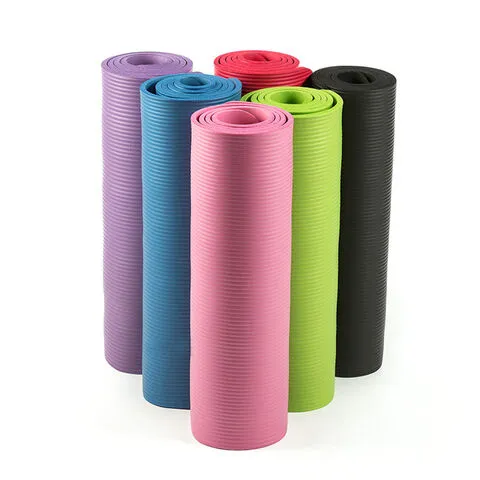 Six rolled yoga mats in purple, blue, pink, green, red, and black standing upright.