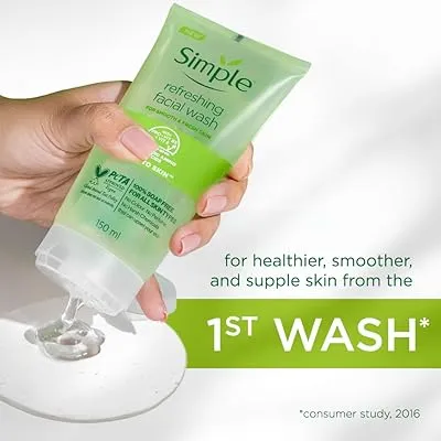Hand squeezing Simple Refreshing Facial Wash onto a white surface.