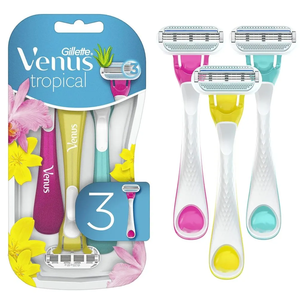 Three colorful Venus Tropical razors with pink, yellow, and green accents in packaging.