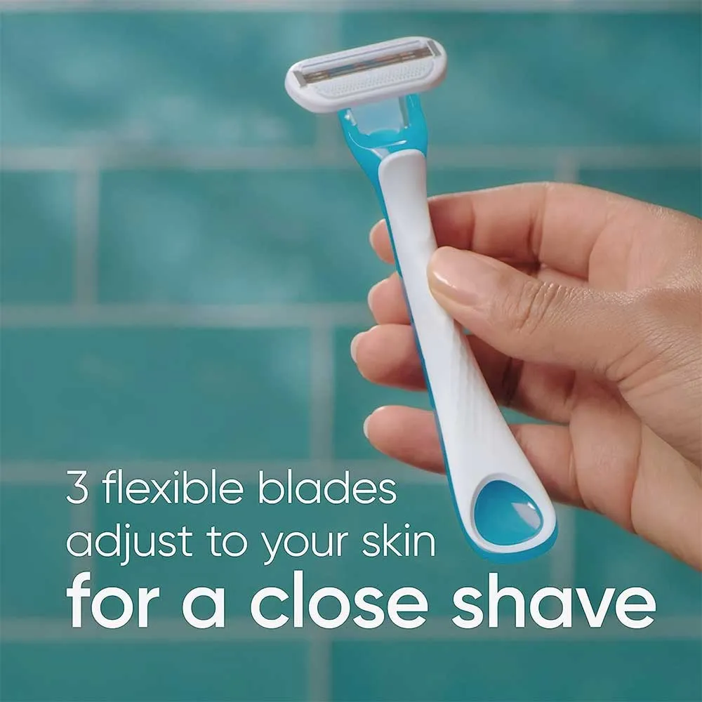 Hand holding a blue and white razor in front of teal tiled wall.