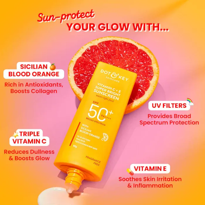 Sunscreen tube with SPF 50+ on a vibrant background, half grapefruit behind it.