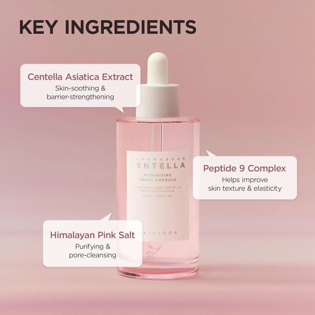 Pink serum bottle with dropper on a gradient pink background, featuring key ingredient callouts.
