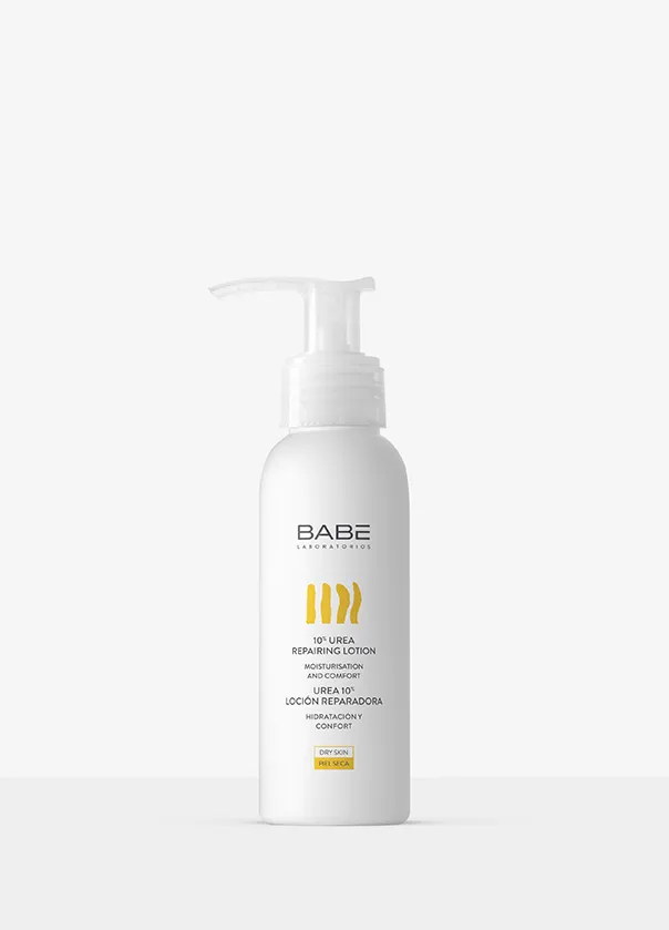 White pump bottle of hair care product with yellow and black text on a plain background.