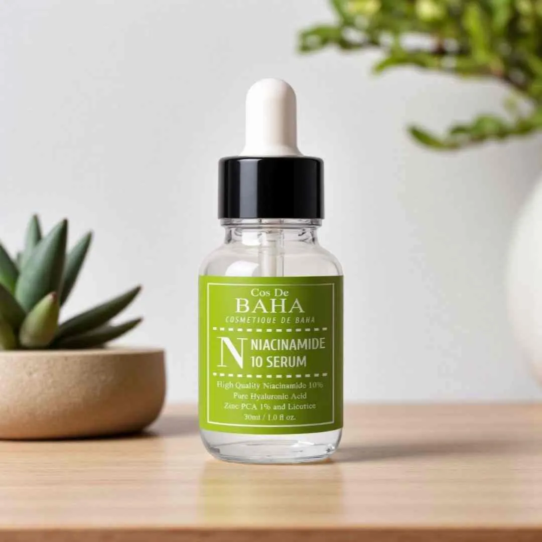 Clear dropper bottle of BAHA niacinamide serum on a wooden surface with plants in background.