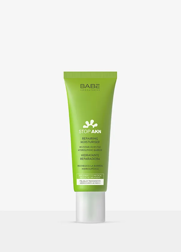 Green skincare product tube with white cap standing upright on a white background.