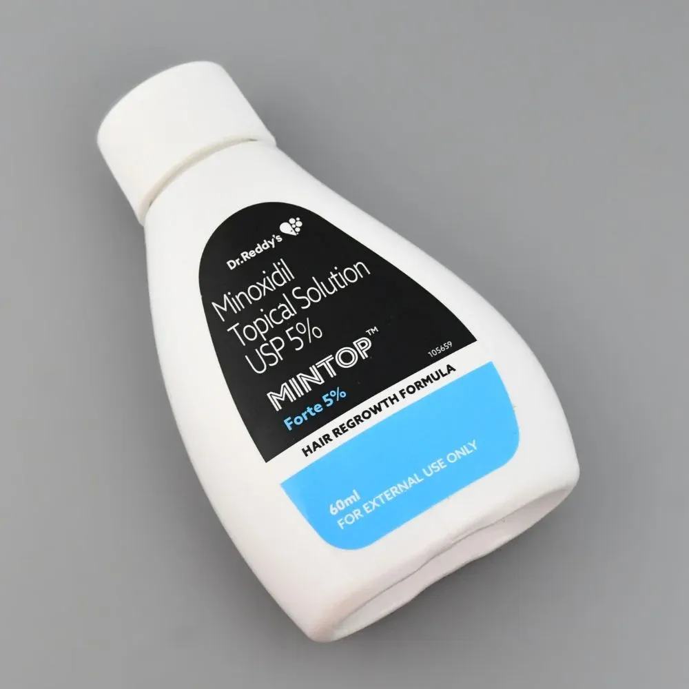 White bottle of Mintop hair regrowth solution on a gray background.