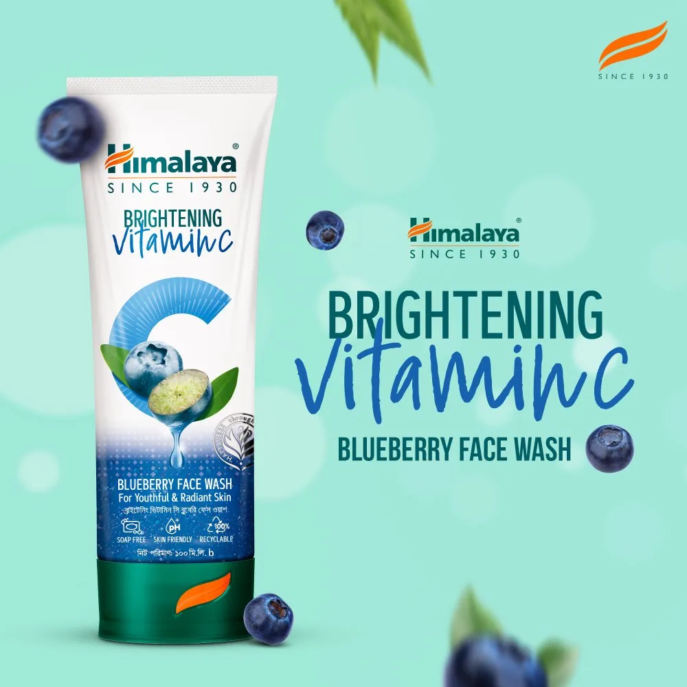 Himalaya Brightening Vitamin C Blueberry Face Wash tube with blueberries on a blue background.