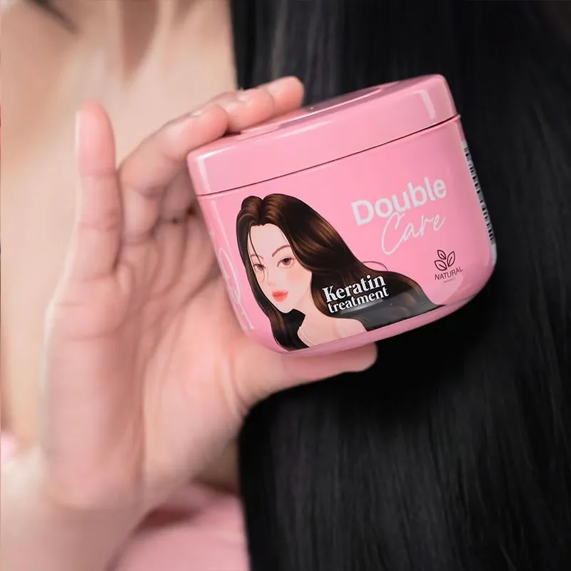 Hand holding a pink hair care product jar near long, smooth black hair.