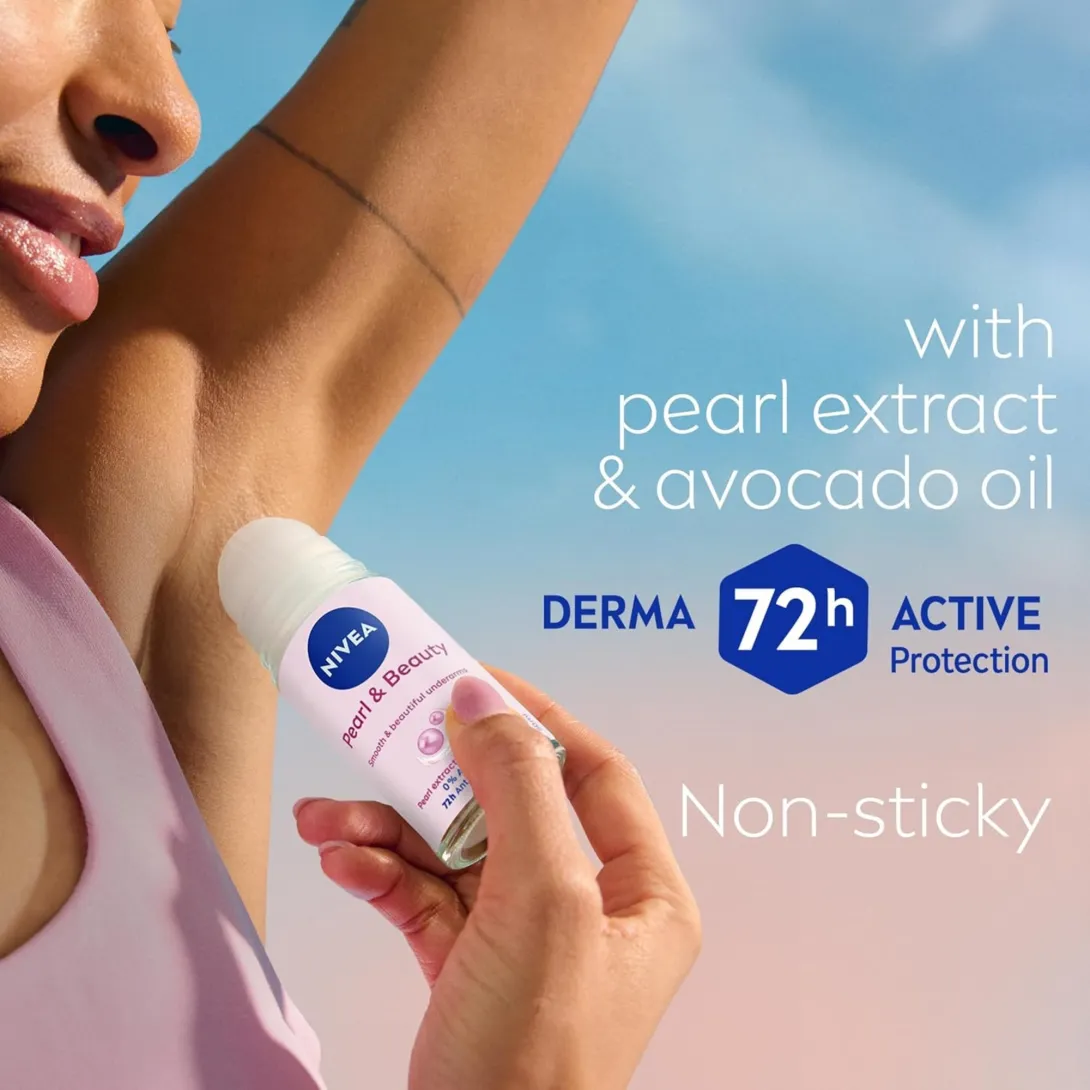 Woman applying Nivea deodorant roll-on to her underarm against a sky background.