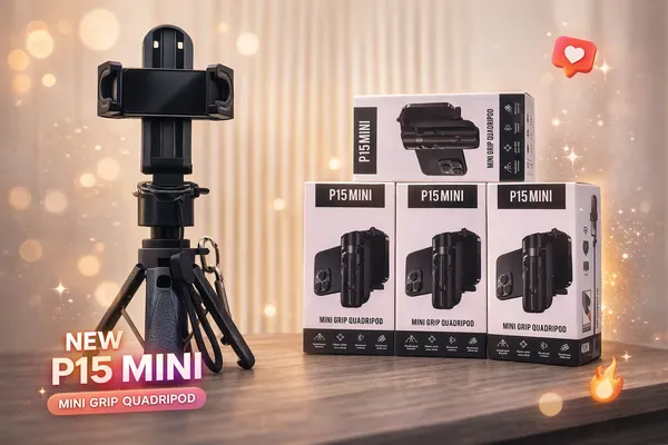 A camera tripod with phone mount next to four stacked product boxes on a table.
