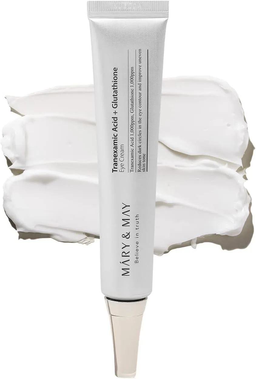 White skincare cream tube with silver cap on swatches of white cream